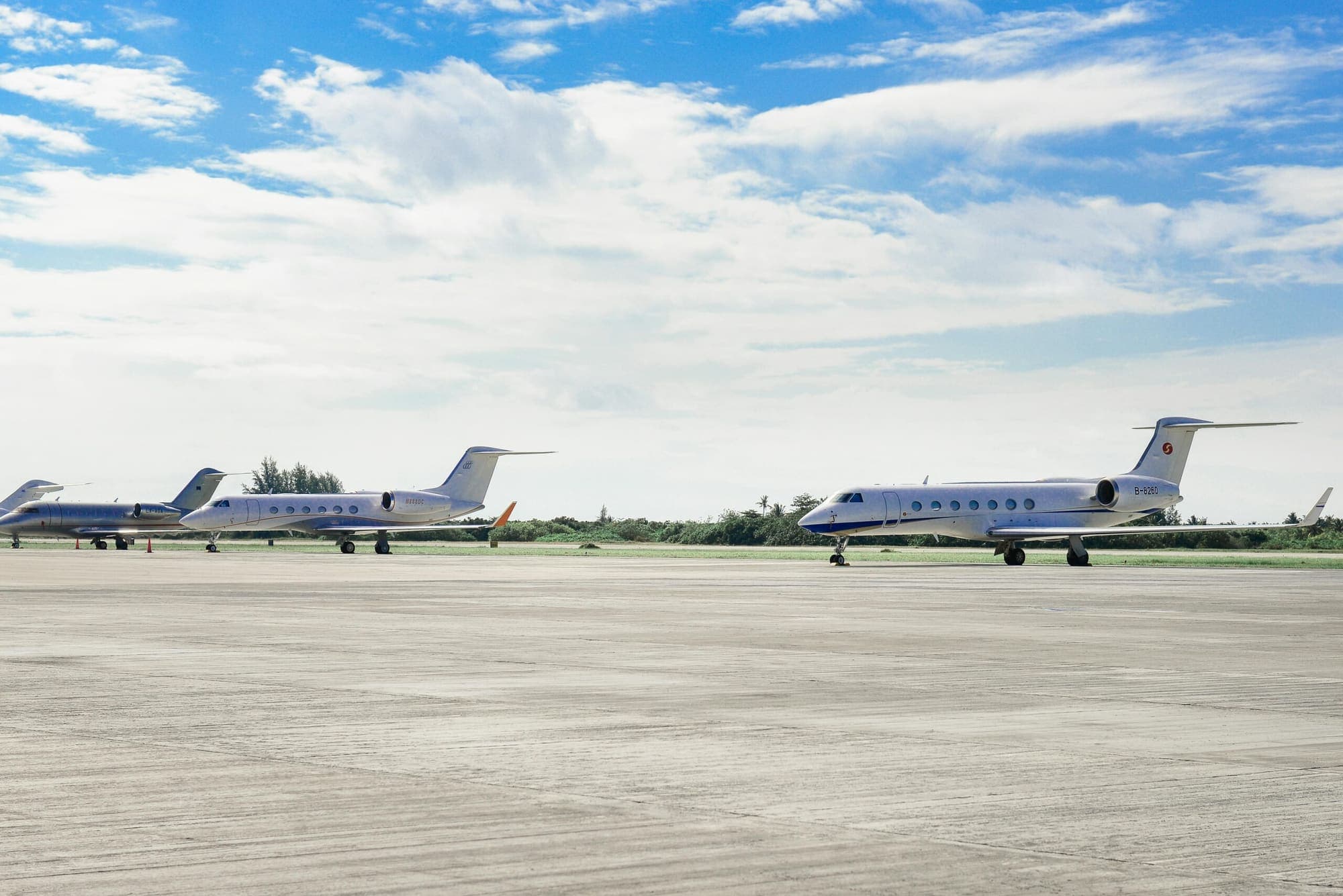 Two business jets parked on the apron