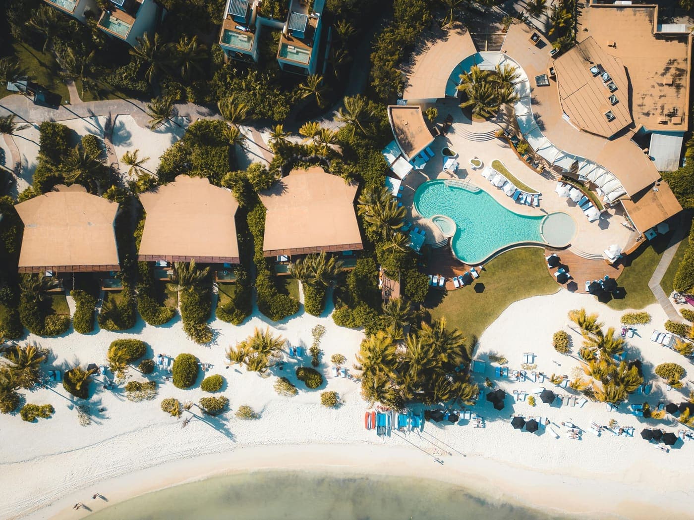 A beachfront resort and its pools seen from the air